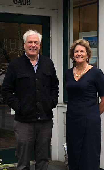 huck hill and katherine jennings in front of office