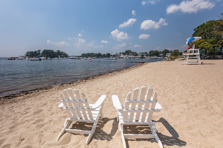 beach with adirondack chairs